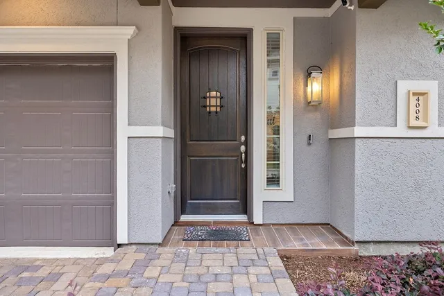 a view of a hallway with wooden floor and a livingroom
