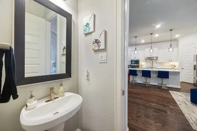 a bathroom with a double vanity sink mirror double and bathtub