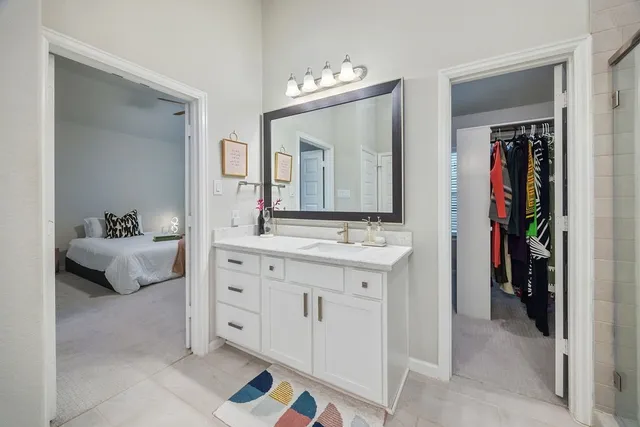 a living room with a flat screen tv on the wall and a window