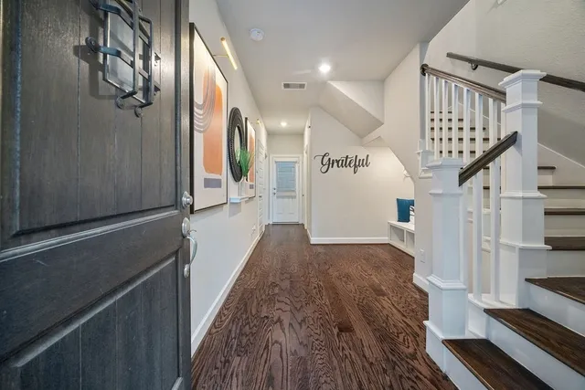 a view of entryway and hall with wooden floor