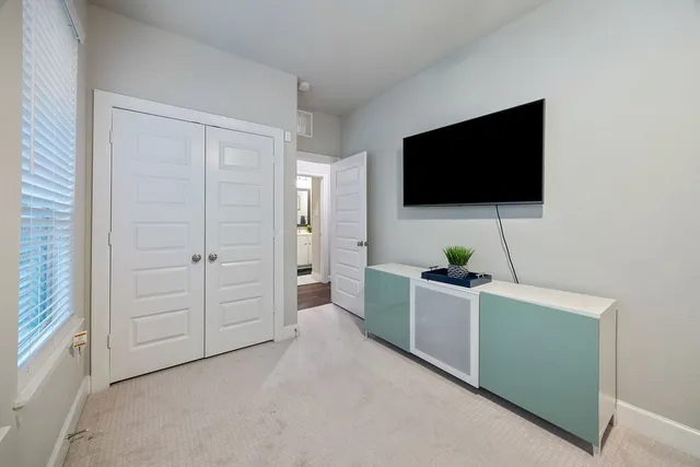 a living room with a fireplace and a flat screen tv