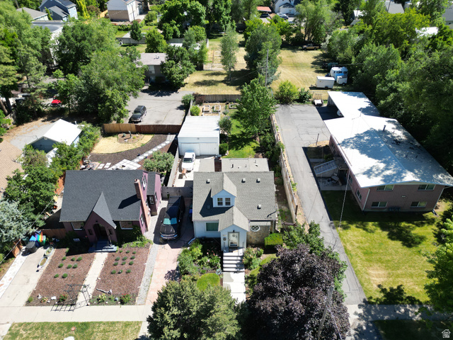 250 West 100 North Logan, UT 84321 - Photo 39 of 46 Aerial perspective showcasing a light-colored property with a dormer window, a mature tree, and a stone retaining wall