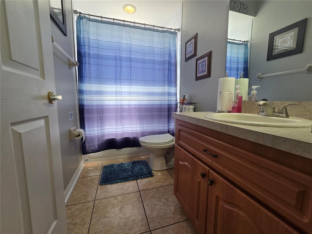 219 Cloverdale Road Winter Haven, FL 33884 - Photo 24 of 29 a bathroom with a sink a toilet and shower