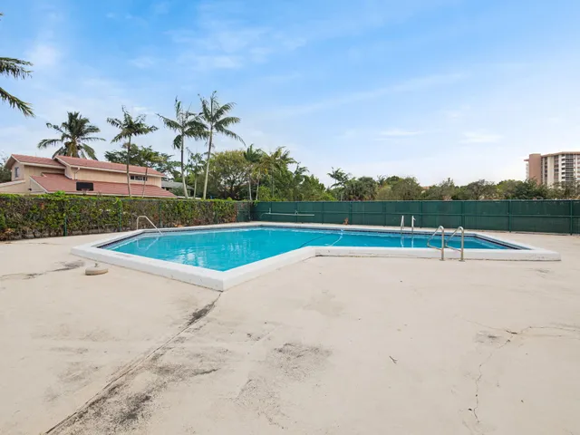 a view of a swimming pool and a yard