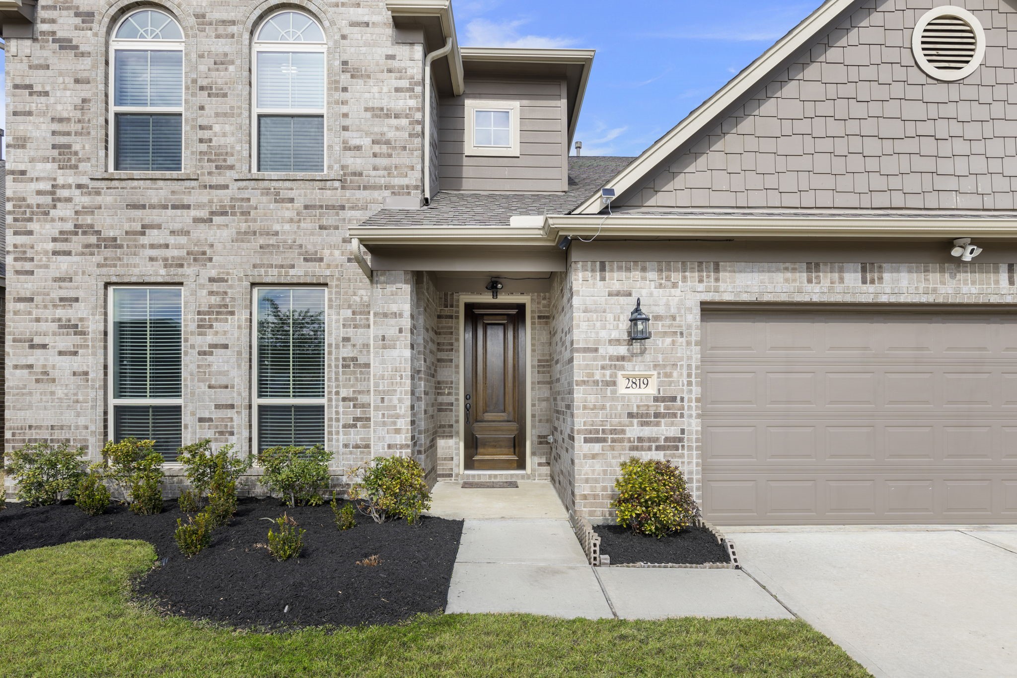 2819 Bradbury Hills Road Spring, TX 77373 - Photo 5 of 50 This charming home features a welcoming porch, framed by elegant brickwork and lush landscaping, promising a warm and inviting entrance.