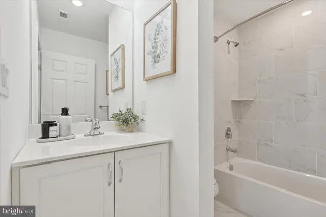 a kitchen with stainless steel appliances granite countertop a refrigerator a stove and a sink with wooden floors