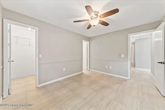 an empty room with closet and windows