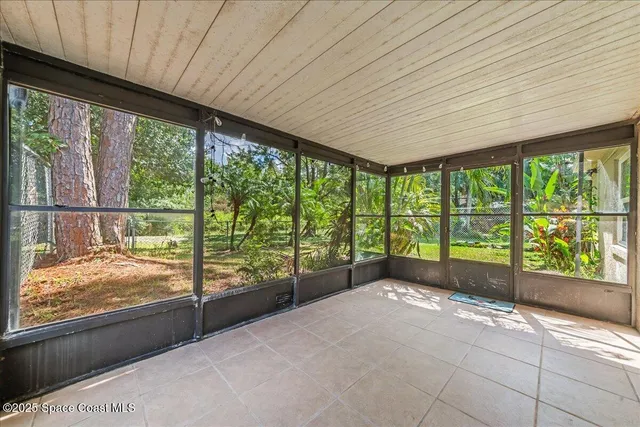 a view of backyard with large windows