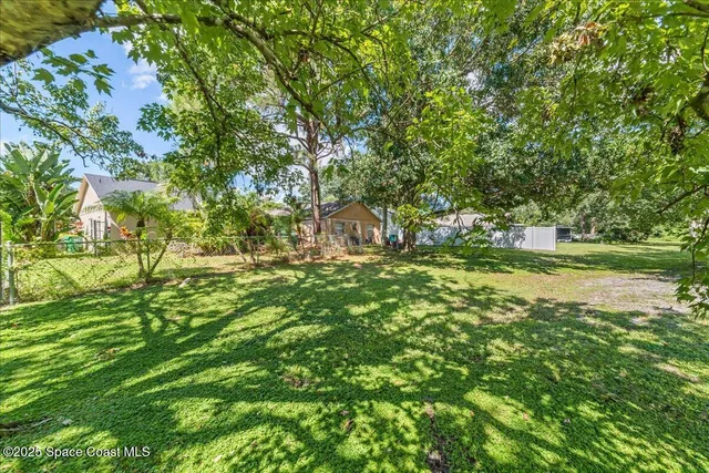 a backyard of a house with a yard and outdoor seating