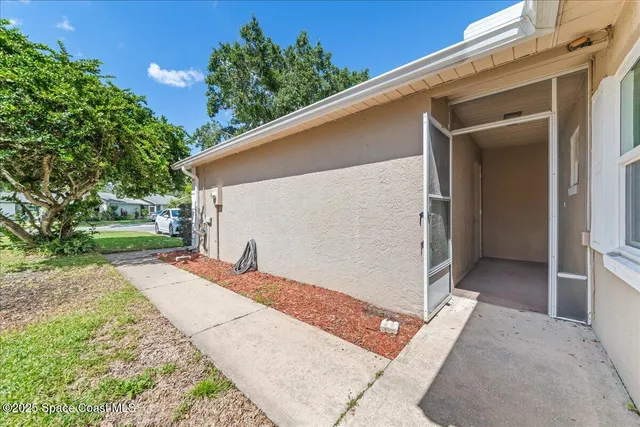 a backyard of a house with outdoor seating and a garage