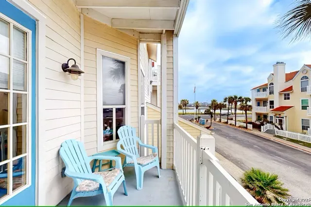 a balcony with table and chairs