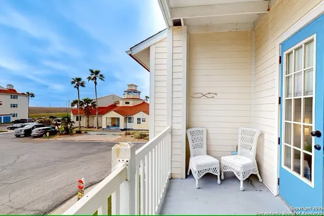 a view of a patio with a chairs and table in the balcony