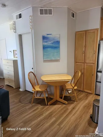 a work room with furniture and a wooden floor