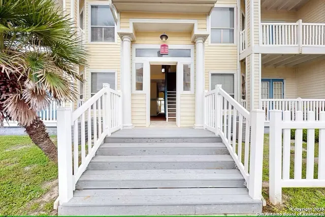 a view of a house with a small deck
