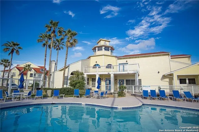 a front view of building with yard and outdoor seating