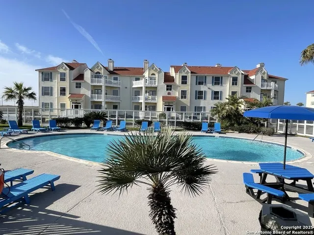 a view of swimming pool outdoor seating and city view