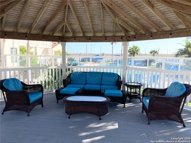 a outdoor living space with furniture and umbrella
