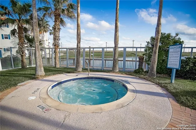 a view of a swimming pool with a yard
