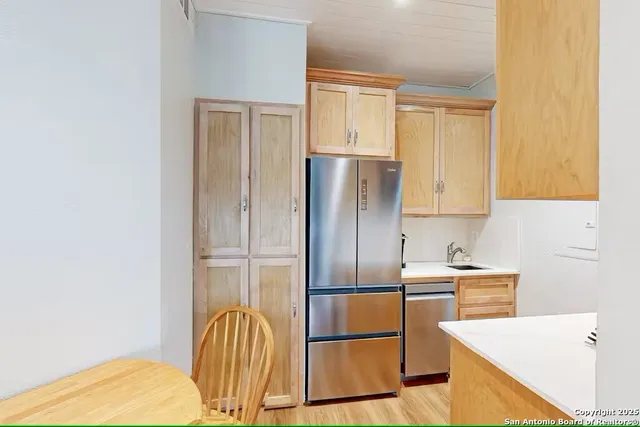 a kitchen with stainless steel appliances a refrigerator and a sink
