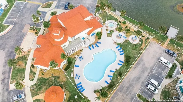 aerial view of a swimming pool with outdoor seating