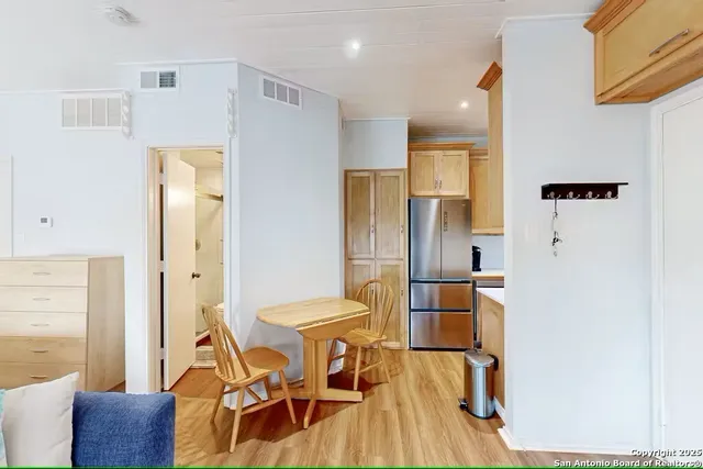 a view of a dining room with furniture and wooden floor