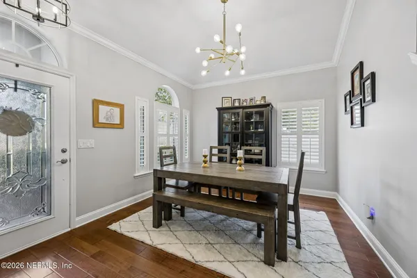 a living room with furniture kitchen and a table