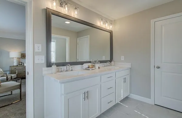 a bathroom with a double vanity sink and a mirror