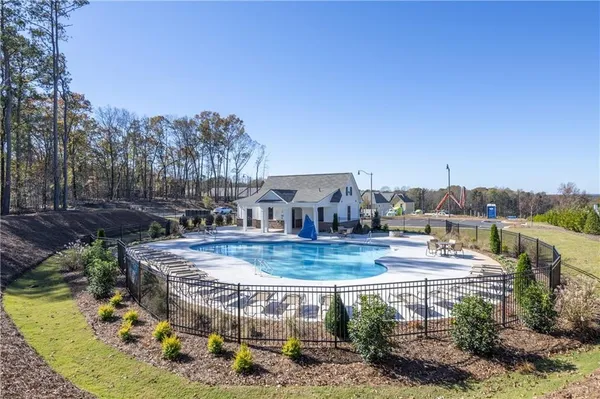 a view of a swimming pool with a yard