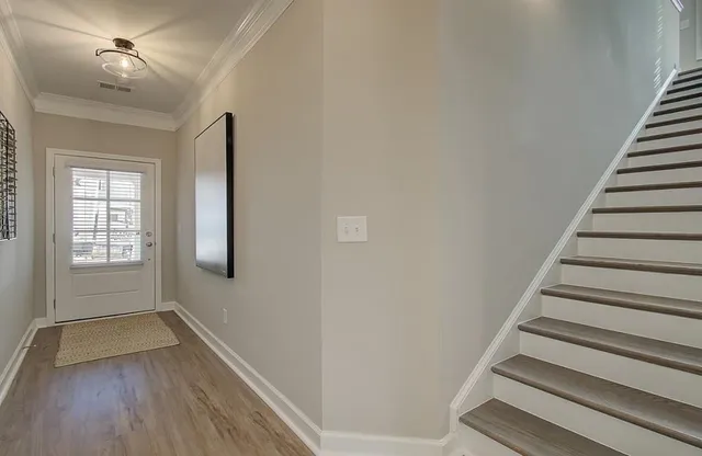 a view of entryway with stairs and wooden floor