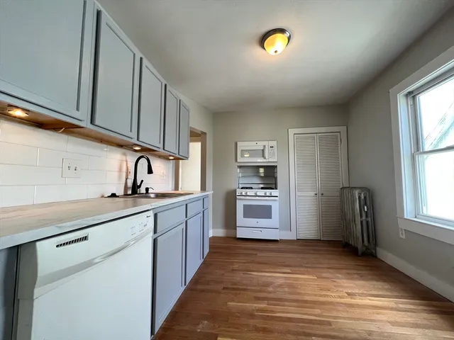 a kitchen with stainless steel appliances a refrigerator sink and cabinets