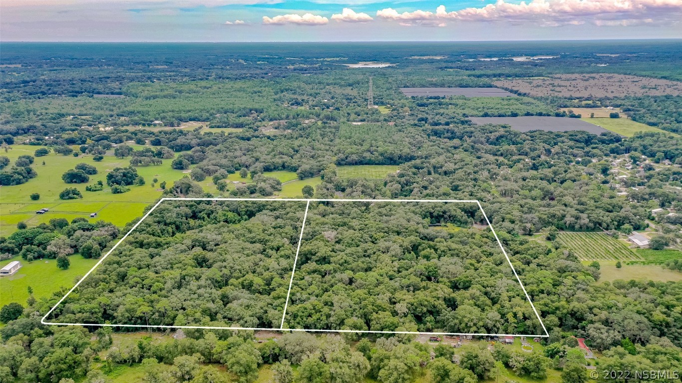 0 Reynolds Road De Leon Springs, FL 32130 - Photo 12 of 12 a view of a field with an outdoor space