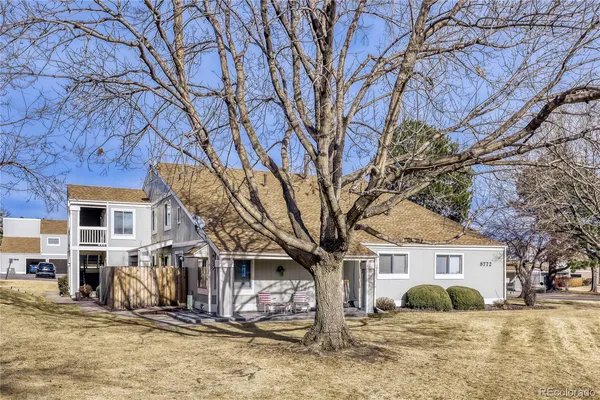 a front view of a house with a yard covered with snow