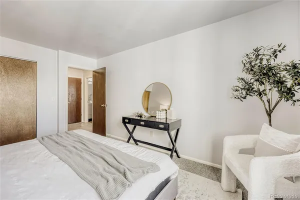 a bedroom with a bed and a couch