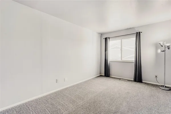 a view of an empty room and closet area