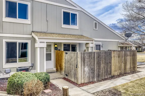 a view of a house with wooden fence