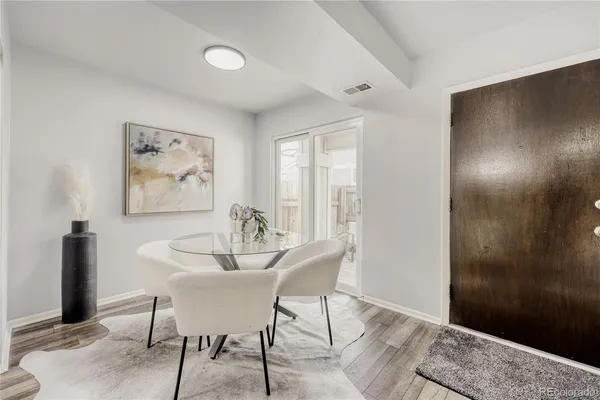a dining room with furniture and window