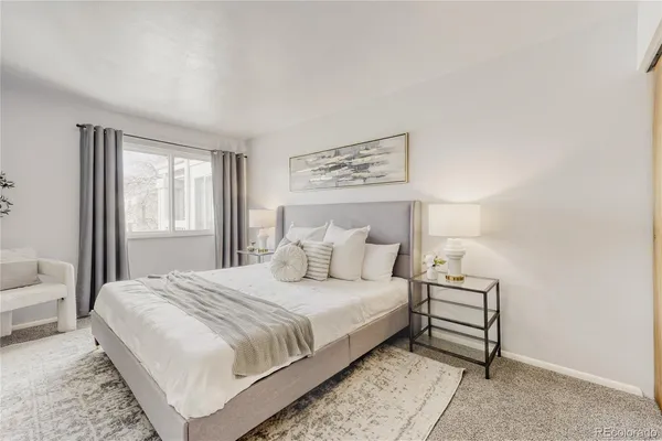 a bedroom with a bed and a night stand