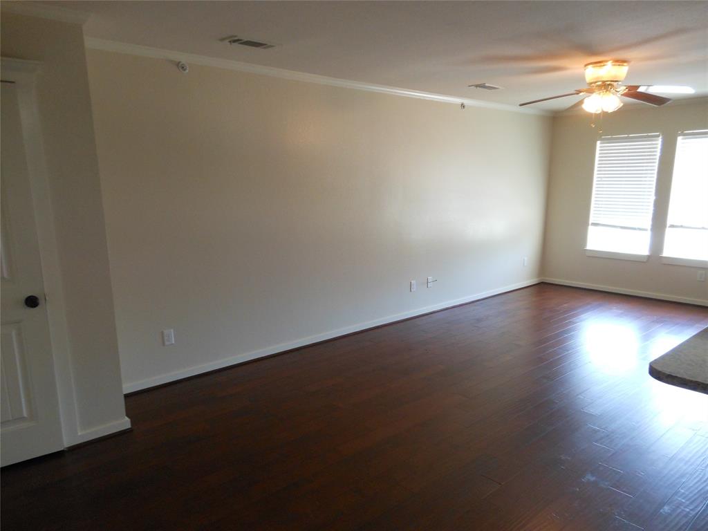 206 Highway 342, Unit K Red Oak, TX 75154 - Photo 6 of 14 an empty room with wooden floor and windows in it