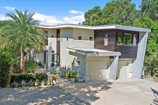 an aerial view of a house with a yard and lake view