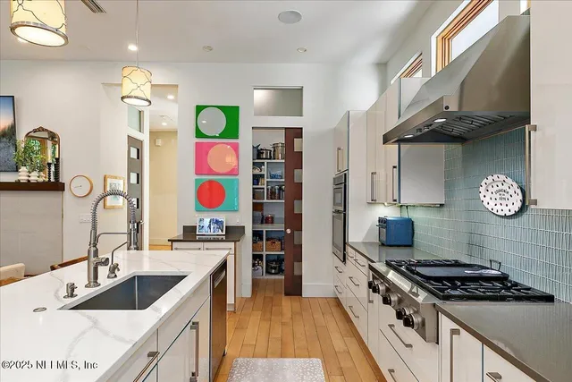 an aerial view of a house with a yard and lake view