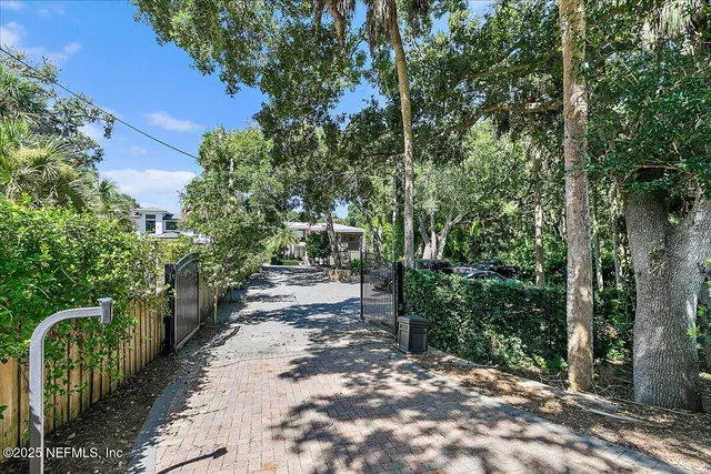 a view of a bedroom with wooden floor and stairs