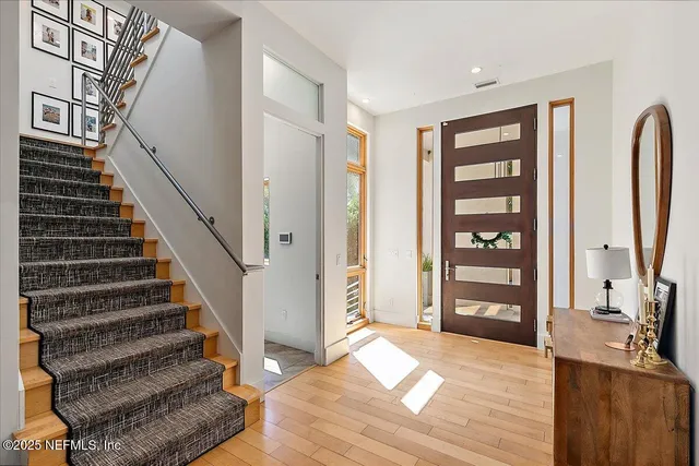 a bathroom with a granite countertop toilet a sink and a mirror
