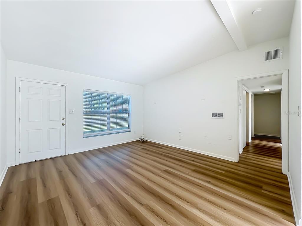 2001 Conway Gardens Road Orlando, FL 32812 - Photo 2 of 11 a view of an empty room with wooden floor and a window