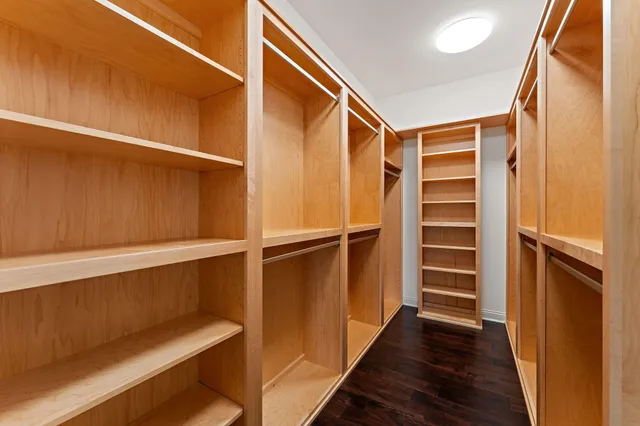 a view of walk in closet with empty racks