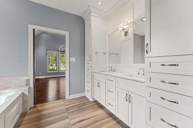 a bathroom with a double vanity sink and mirror