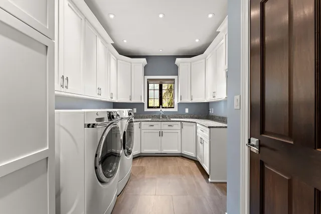 a utility room with sink dryer and washer