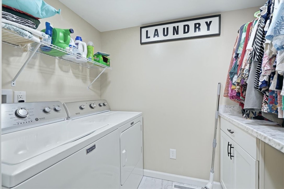 211 Cedar Ridge Drive Westminster, SC 29693 - Photo 19 of 34 An organized laundry room features built-in cabinetry, wire shelving, and durable tile flooring.