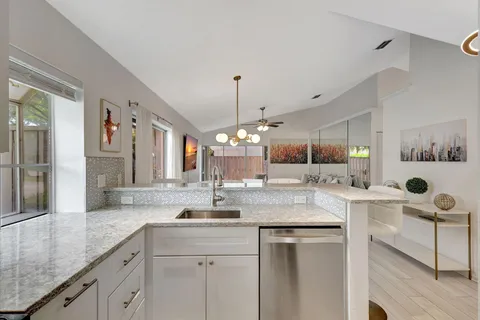 a kitchen with sink and view living room