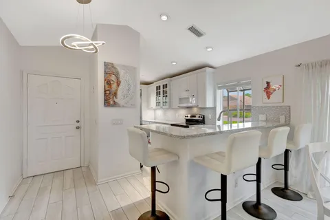 a kitchen with stainless steel appliances a refrigerator and microwave