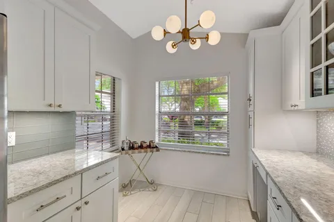 a kitchen with a sink cabinets and window